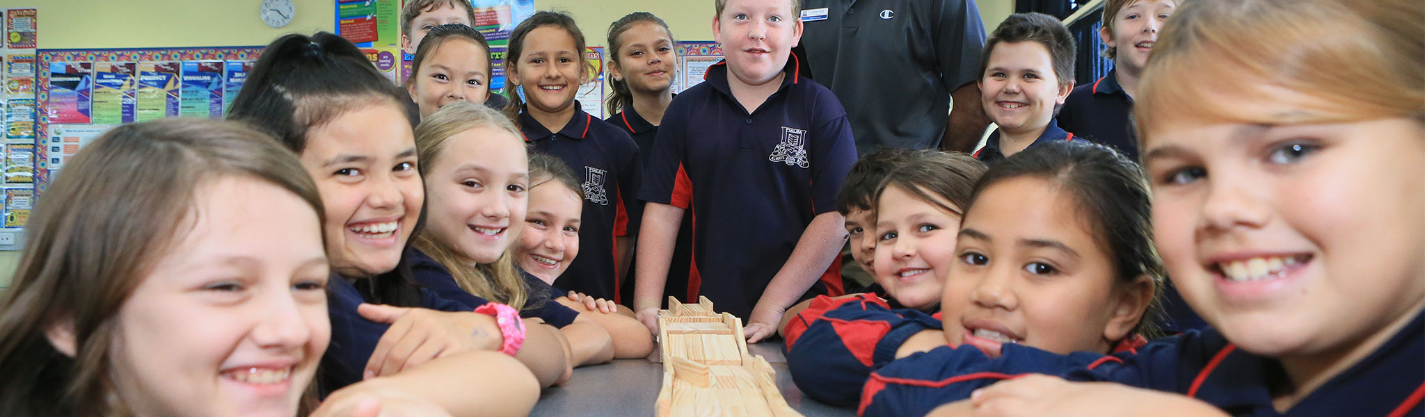 Pialba State School students sitting at table and smiling