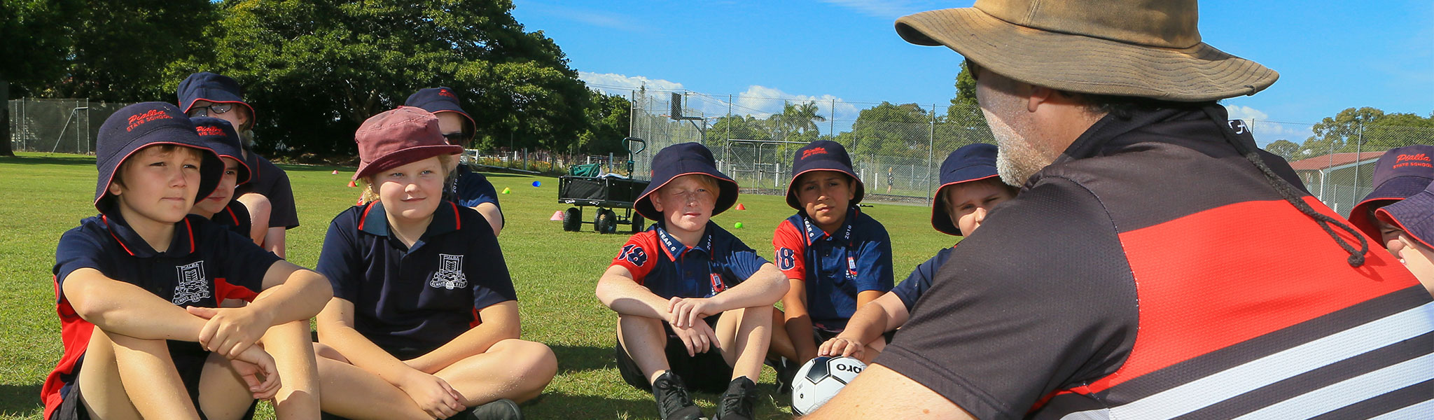 Pialba State School students sitting outside